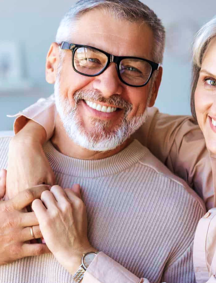  This close-up features a smiling man with a well-maintained beard and teeth, possibly a result of restorative dentistry