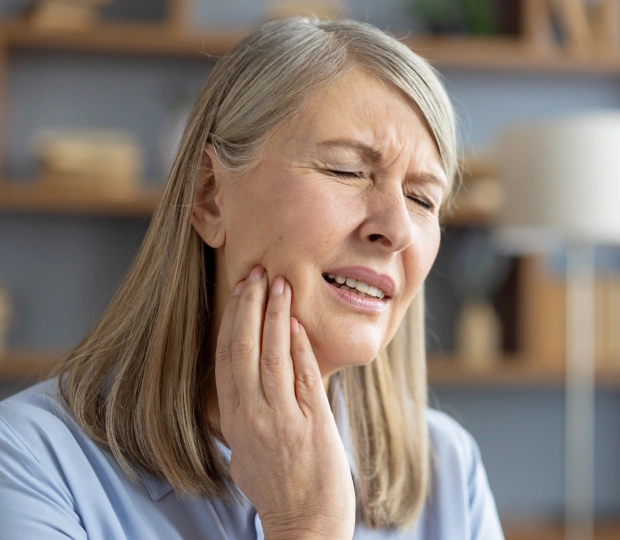 Woman experiencing severe tooth pain, seeking care from an emergency dentist Fort Worth for immediate dental relief